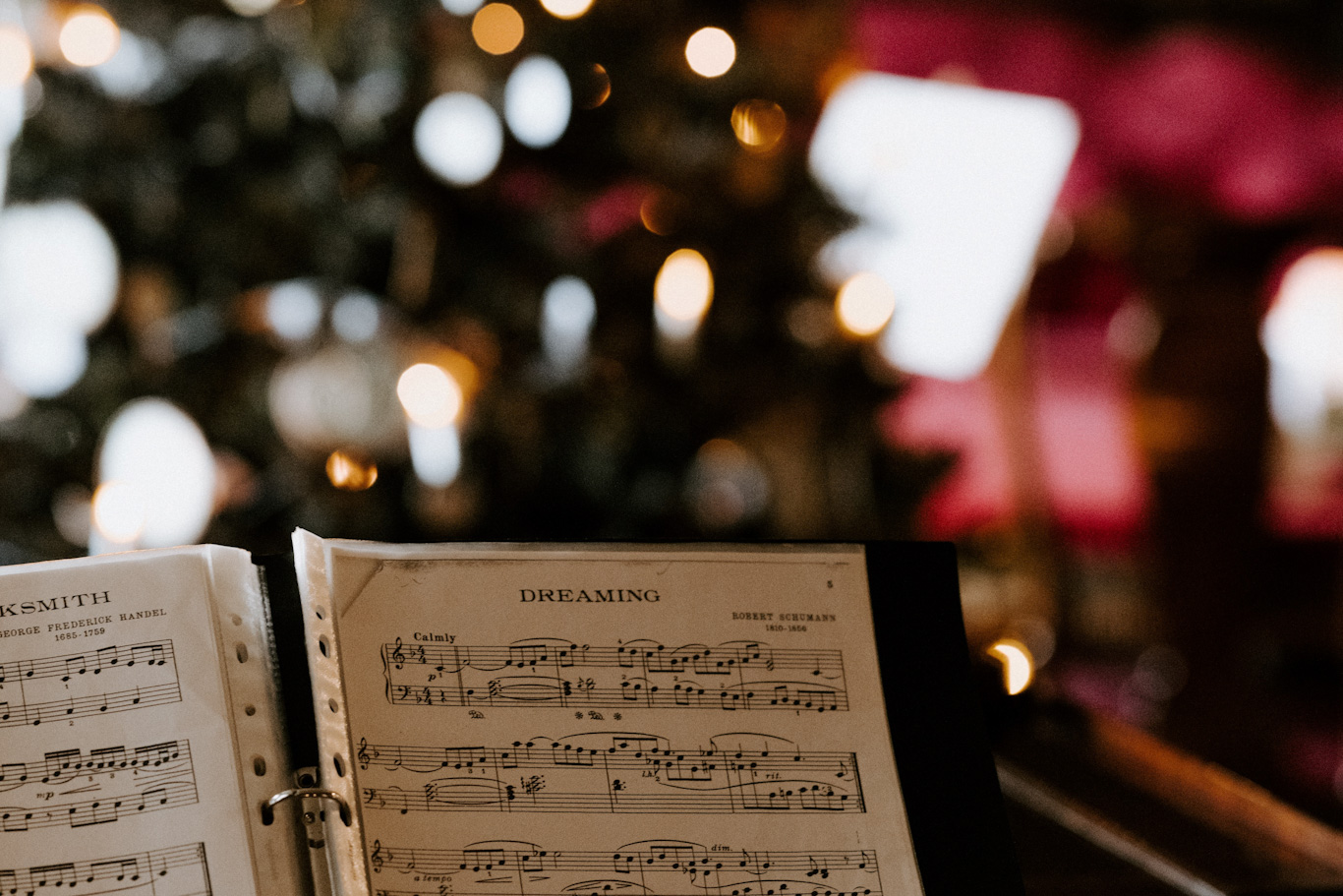 musical score with christmas tree in the background