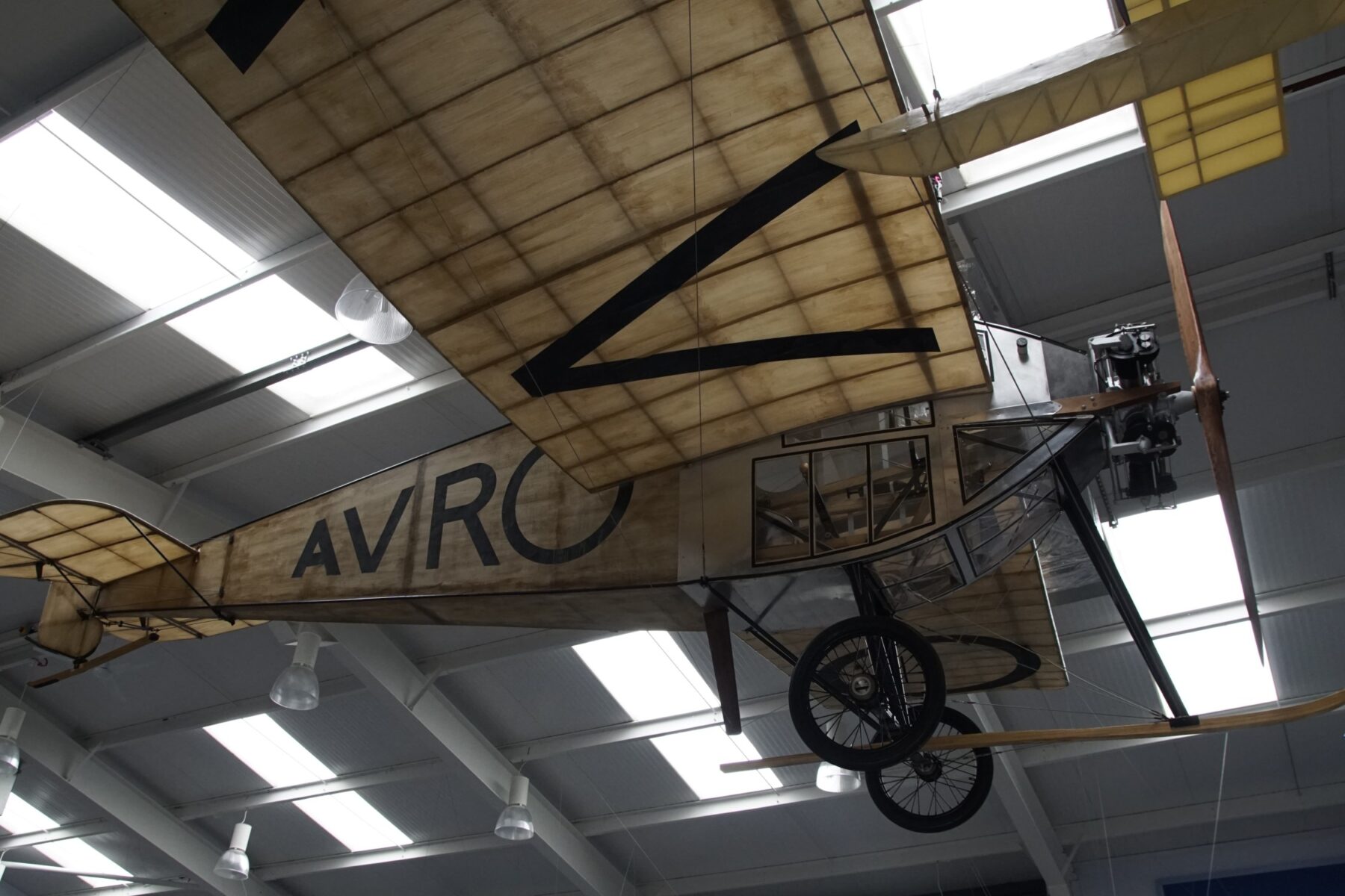 vintage aeroplane suspended from the ceiling of the AVRO museum