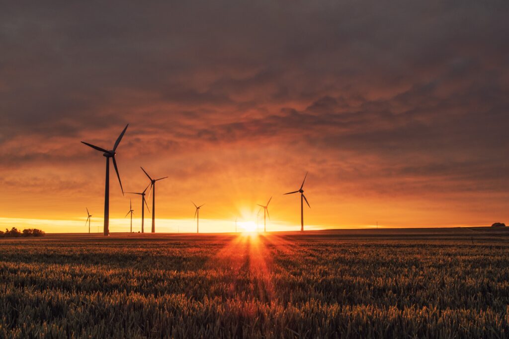 wind farm in rural setting at sunset