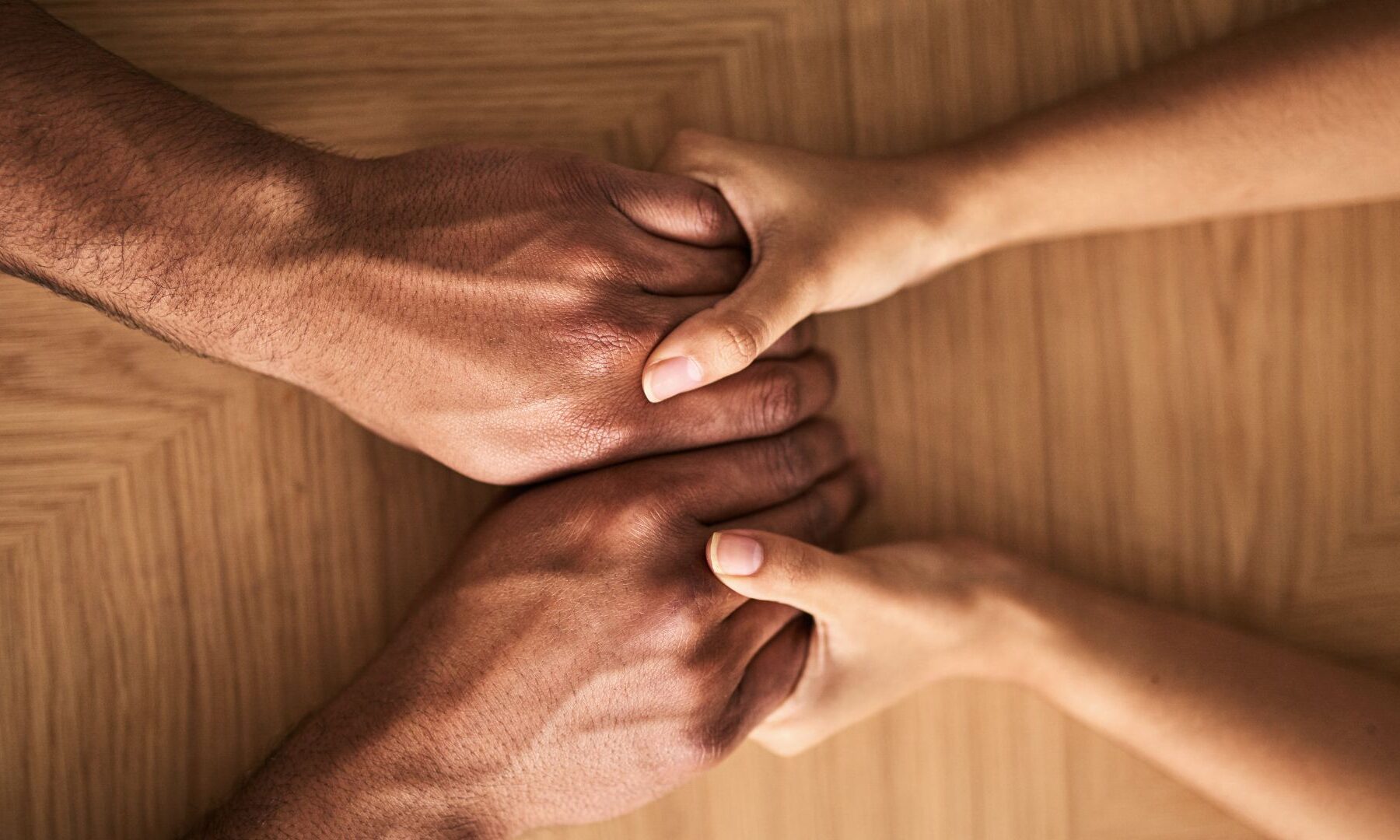 holding hands across a table compassion leadership kindness